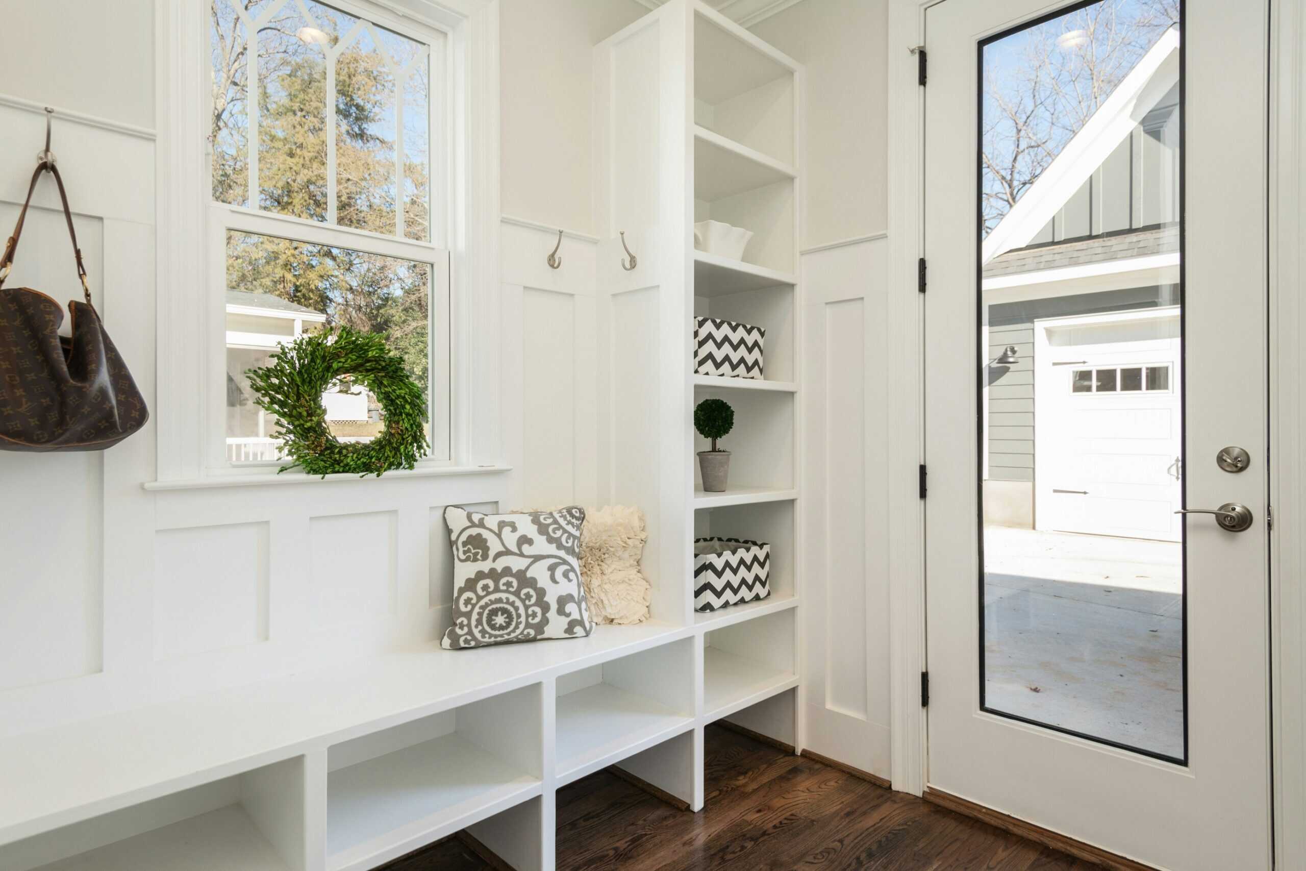 bright image of a front entrance way with custom closets